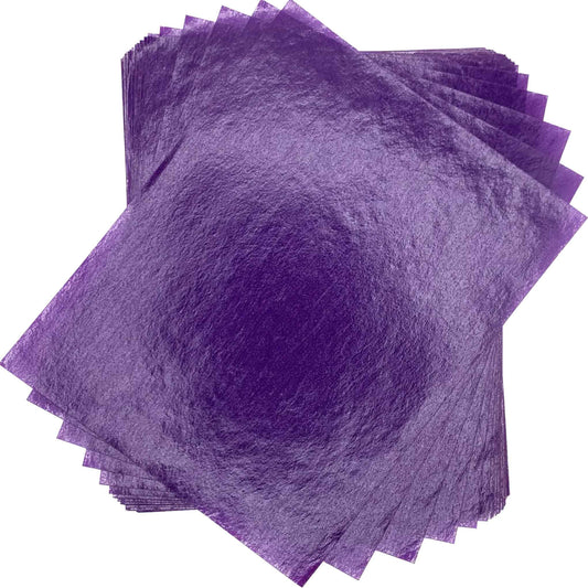 Overlapping stack of rich purple 4" x 5" wax caramel and taffy wrapper sheets arranged against a white background.