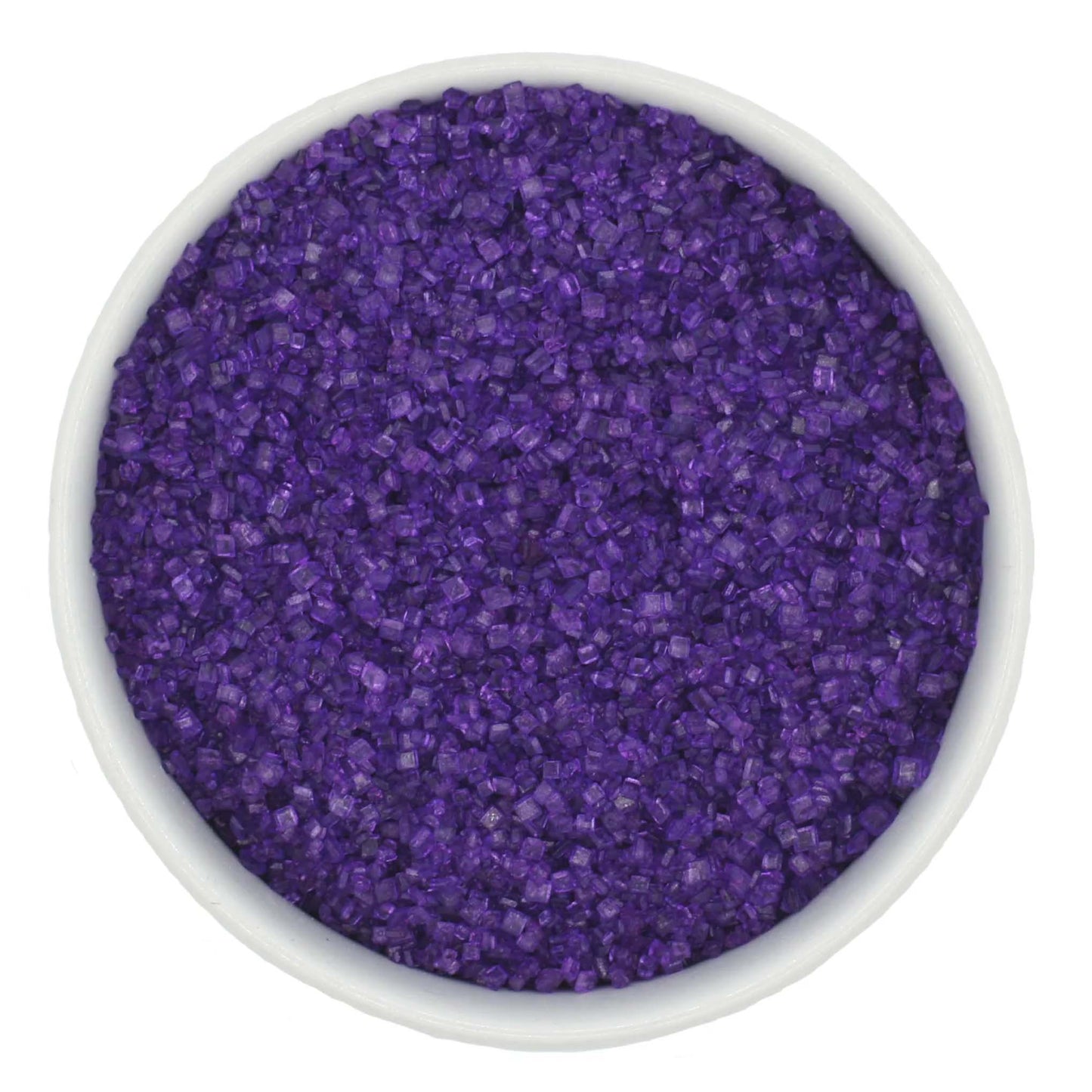 Top-down view of a white bowl filled with deep purple coarse sanding sugar crystals, showing chunky sparkling granules and a saturated violet color.