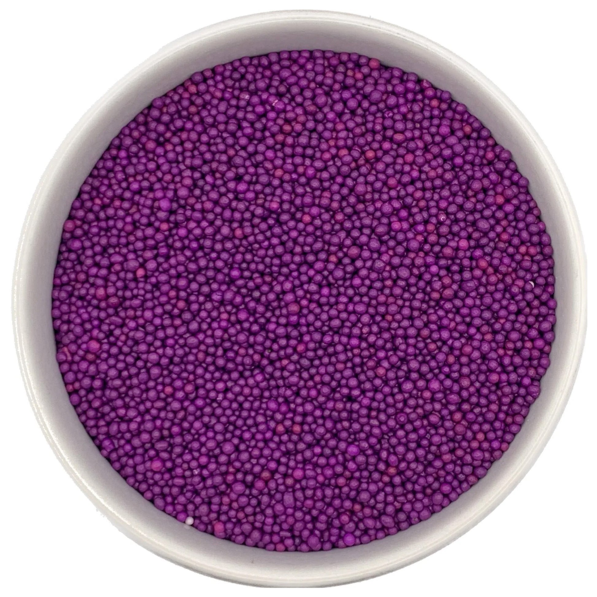 Top-down view of a white bowl filled with purple non-pareils, showing tiny round sprinkle beads in deep violet and magenta-purple shades.