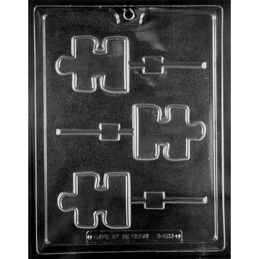 Three-cavity puzzle piece autism awareness chocolate lollipop mold with 3 x 2 3/8-inch shapes, raised borders, and alternating stick channels.