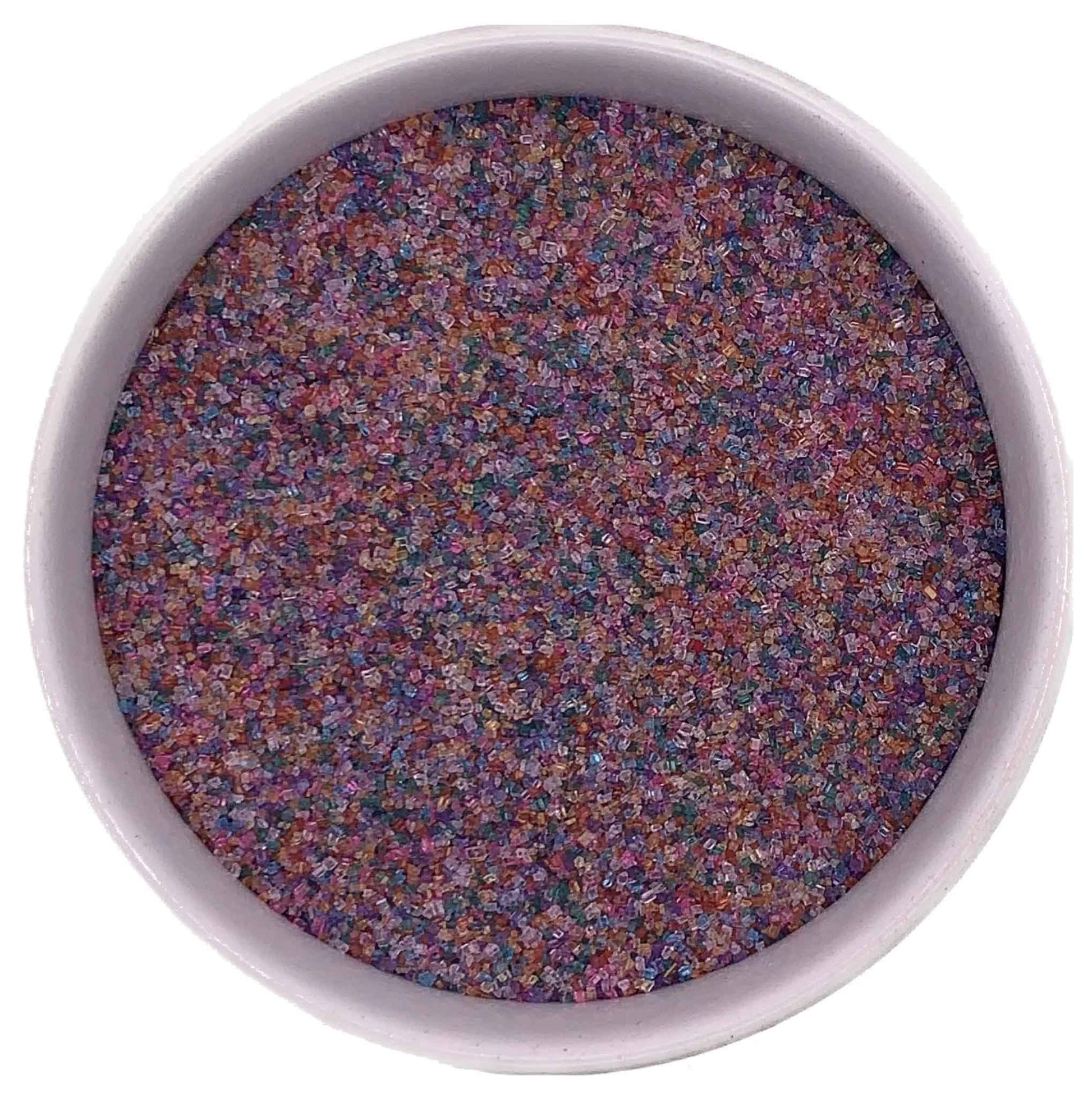 Bowl of rainbow fine sanding sugar crystals in a white container on a white background.