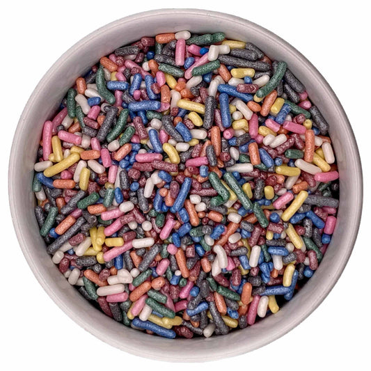 Top-down view of a bowl filled with rainbow shimmer jimmies sprinkles in pink, blue, green, yellow, white, orange, and gray with a pearly sheen.