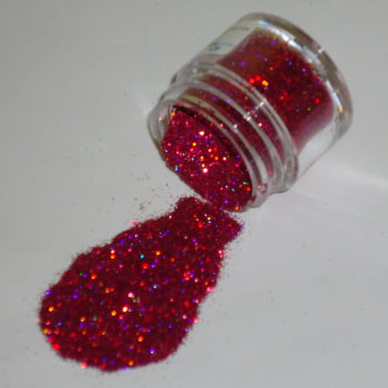 Vivid red Galaxy Glitter Dust pouring from a jar, loaded with intense red sparkle and flashes of electric blue and purple.