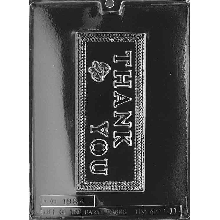 Clear plastic chocolate mold with one large rectangular bar cavity embossed “THANK YOU” in raised lettering with a decorative border and small flourish, on a dark background.