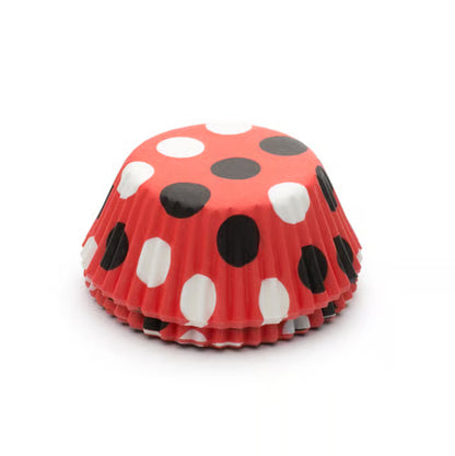 Stack of red baking cups with black and white polka dots, standard size.