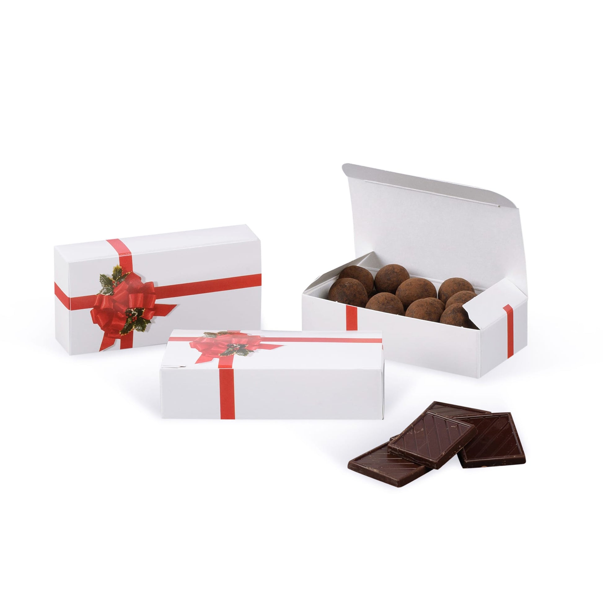 Red ribbon and holly candy boxes shown closed and open on a white background, with chocolate truffles inside the open box and chocolate squares in front.