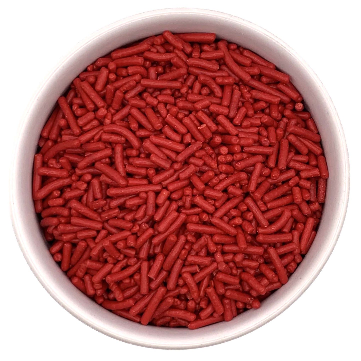 Top-down view of a round container filled with red jimmies sprinkles, showing small cylindrical red candy pieces packed closely together.