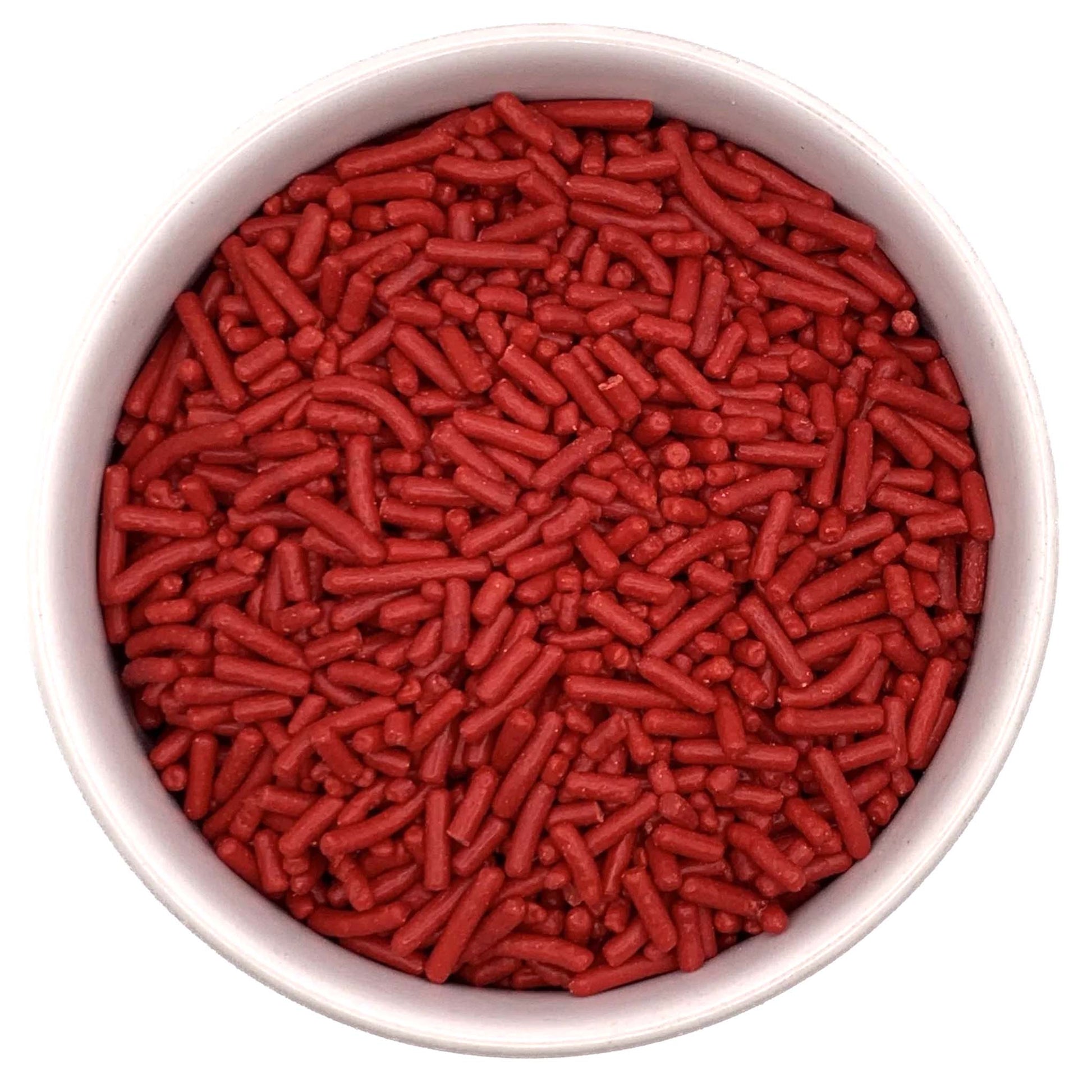 Top-down view of a round container filled with red jimmies sprinkles, showing small cylindrical red candy pieces packed closely together.