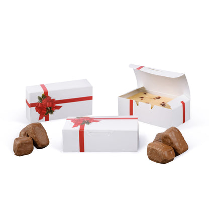 White red ribbon and holly candy box shown closed and open with a confection inside, with chocolates on a white background.