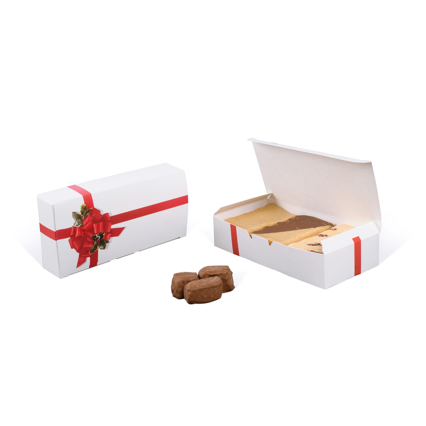 White holiday candy box with red ribbon and holly bow design, shown closed and open with assorted fudge inside.