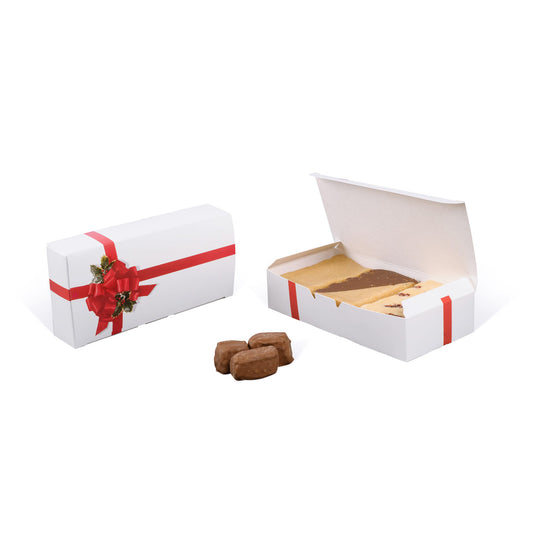 White holiday candy box with red ribbon and holly bow design, shown closed and open with assorted fudge inside.