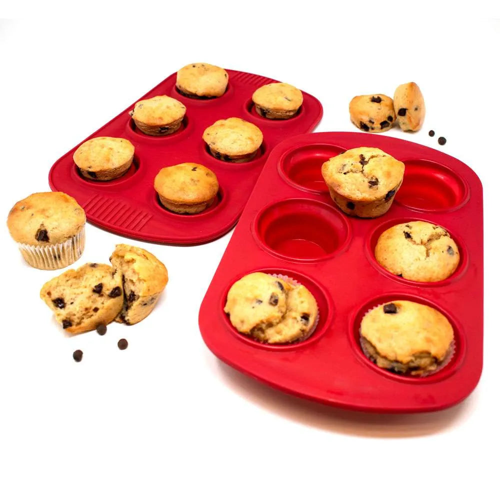 Red silicone muffin pans with baked chocolate chip muffins.