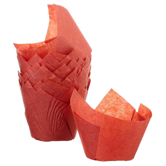 Stack of red tulip baking cups with tall folded paper petals, shown with one red liner opened in front on a white background.