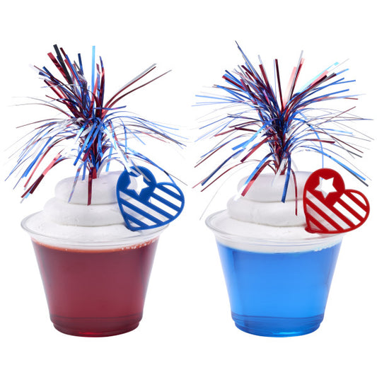 Patriotic red and blue gelatin desserts topped with whipped cream, pom-poms, and star-striped heart picks.