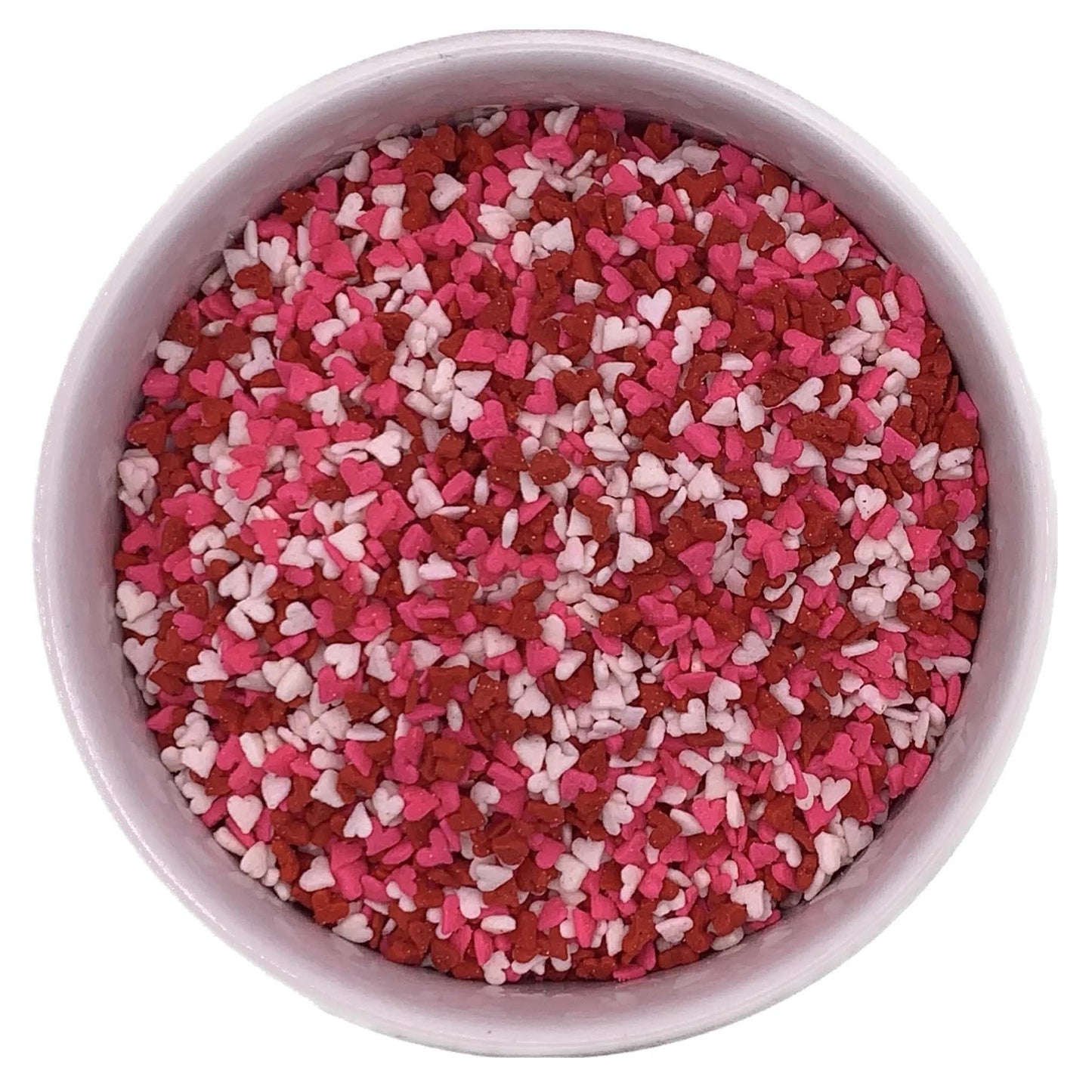 Bowl filled with red, pink, and white mini heart sprinkles, perfect for decorating Valentine's Day cupcakes, cookies, and cakes.