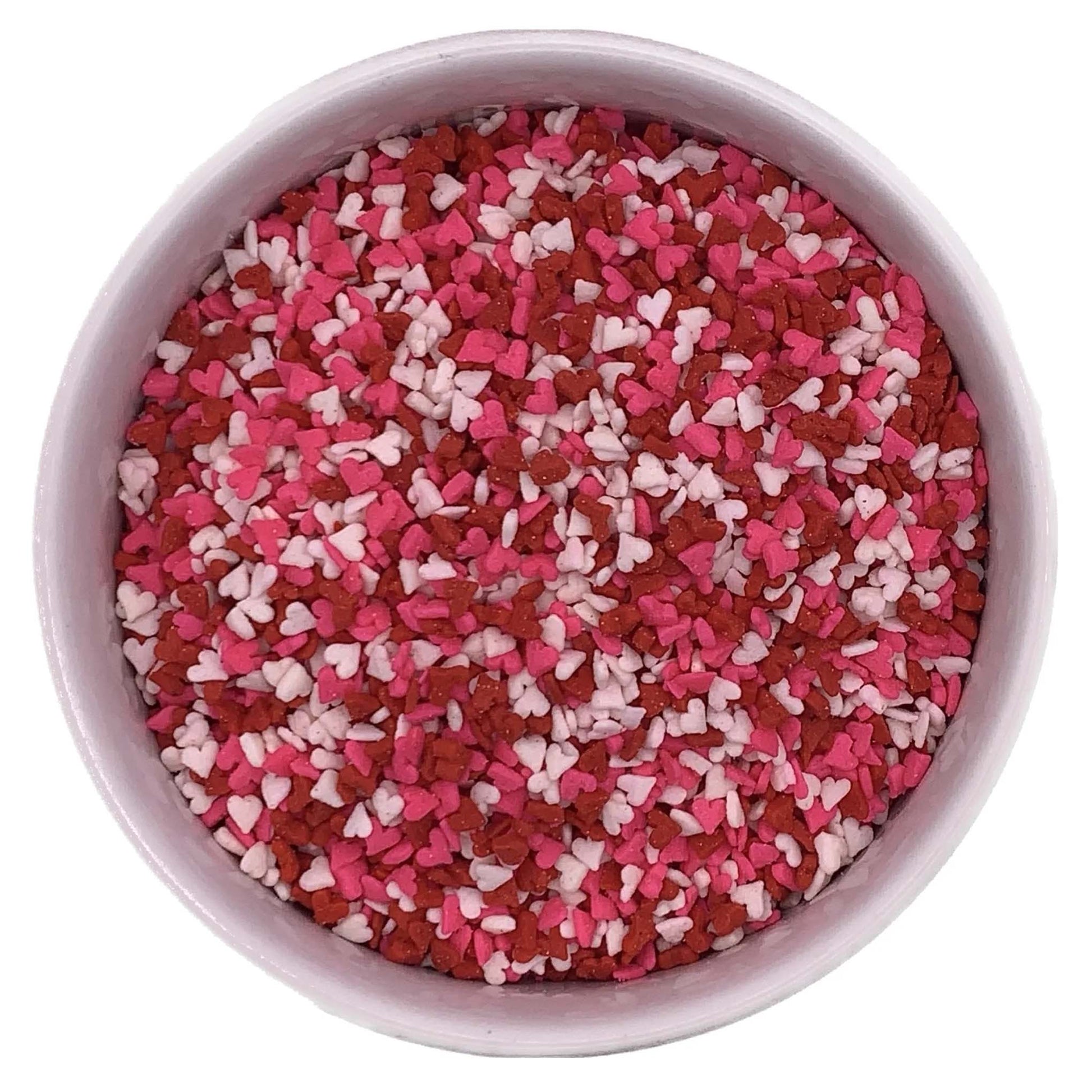 Bowl filled with red, pink, and white mini heart sprinkles, perfect for decorating Valentine's Day cupcakes, cookies, and cakes.