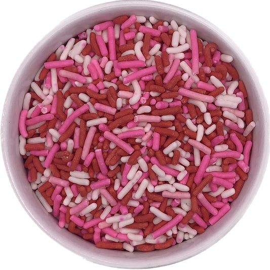 Bowl of red, pink, and white jimmies perfect for Valentine’s Day dessert decorating, sold in a 4 oz container.