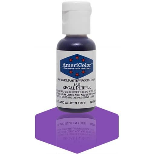 A bottle of AmeriColor Regal Purple soft gel paste food coloring with a white cap, blue label, and red stars, placed on a deep purple reflective surface with the bottle’s reflection clearly visible.