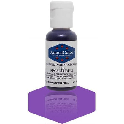 A bottle of AmeriColor Regal Purple soft gel paste food coloring with a white cap, blue label, and red stars, placed on a deep purple reflective surface with the bottle’s reflection clearly visible.