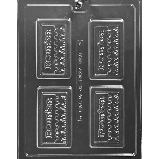 Clear plastic chocolate mold with four rectangular cavities featuring raised “Reunion” lettering and a decorative border pattern, shown on a dark background.