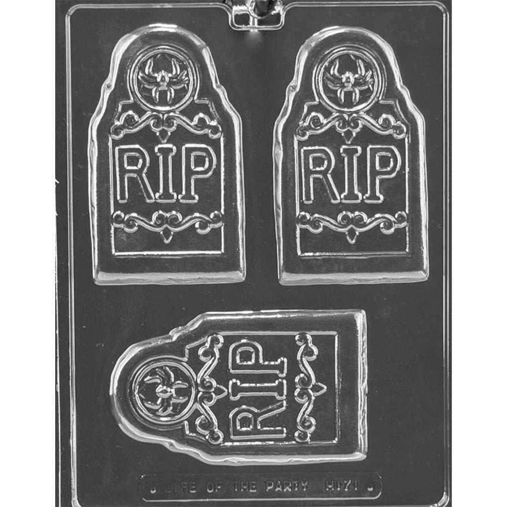 Clear plastic chocolate mold photographed on a dark background, showing three tombstone-shaped cavities with raised RIP lettering, decorative scroll details, and a spider at the top.