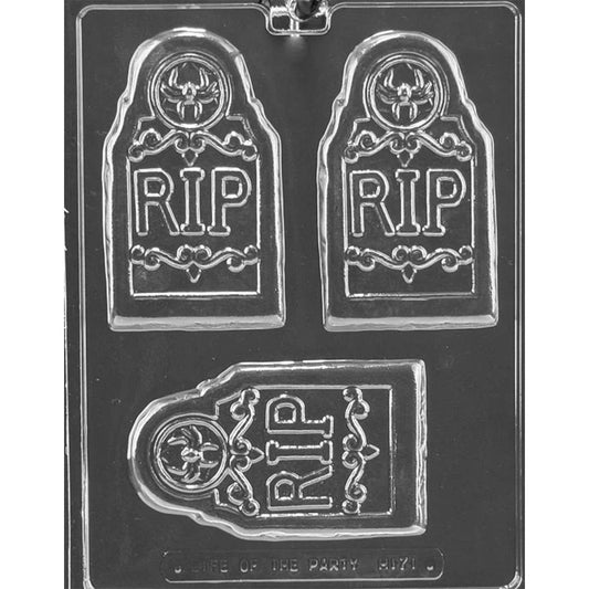Clear plastic chocolate mold photographed on a dark background, showing three tombstone-shaped cavities with raised RIP lettering, decorative scroll details, and a spider at the top.