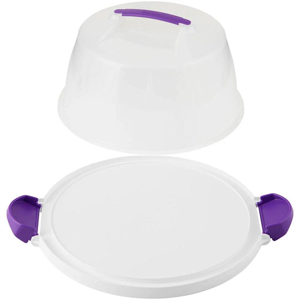 Round cake and cupcake carrier with a white reversible base, translucent lid, purple carrying handle, and two purple locking latches