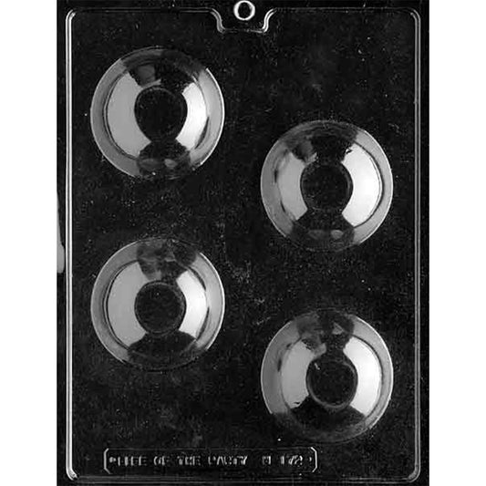 Clear chocolate mold with four large round dome cavities arranged in alternating rows against a dark background, each with a smooth curved surface.
