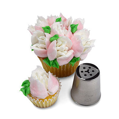 Cupcake decorated with intricate white and pink frosting flowers and green leaves, crafted using Russian Piping Tip #245. The piping tip tool is displayed next to the cupcake, showcasing its detailed design.