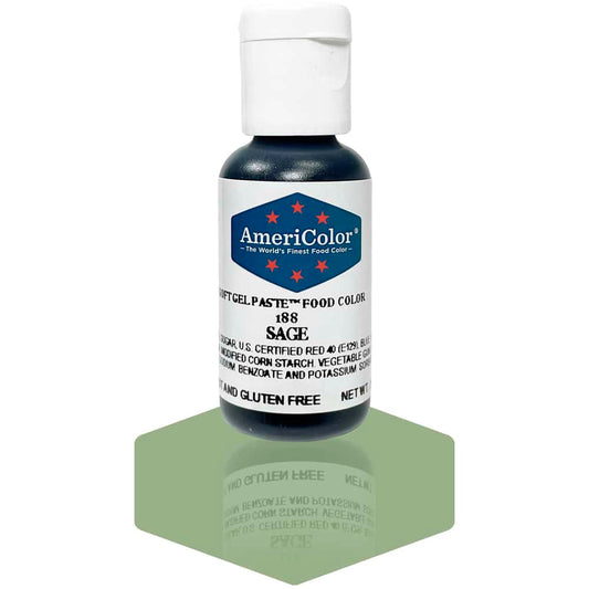 A bottle of AmeriColor Sage soft gel paste food coloring with a white cap, blue label, and red stars, positioned on a sage green reflective surface with the bottle’s reflection clearly visible.