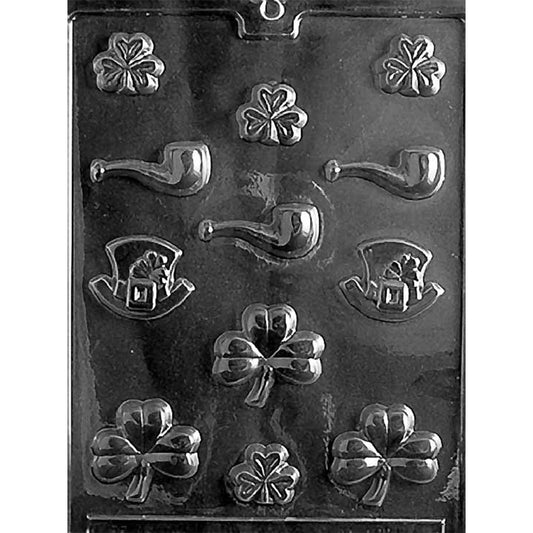 St. Patrick’s Day assortment chocolate mold with multiple small cavities shaped like shamrocks, curved pipes, and leprechaun hats, plus several larger clover shapes, shown in clear plastic.