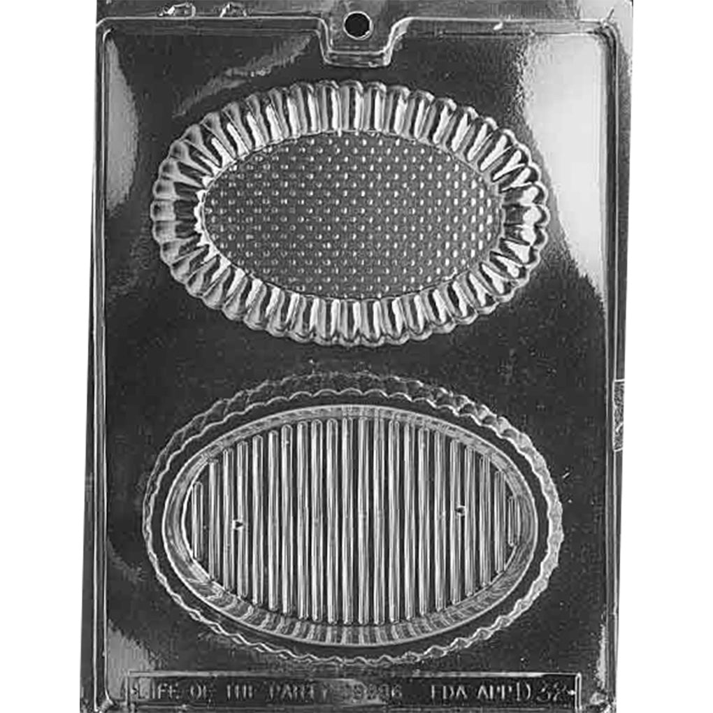 Clear plastic chocolate mold with two large oval cavities, one with a scalloped rim lid design and one deep oval base with lined texture, on a dark background.