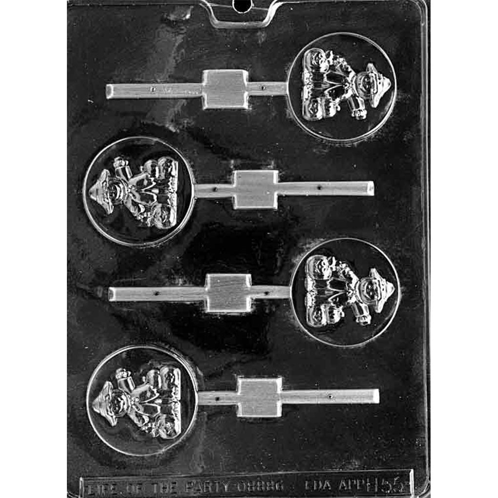 Clear plastic chocolate lollipop mold photographed on a black background with four round lollipop cavities, each featuring a scarecrow design in the center and a stick channel.