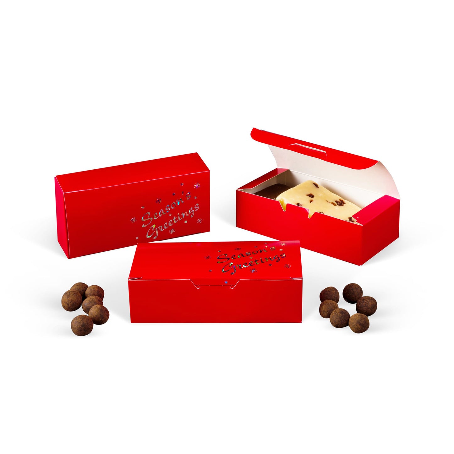Red Seasons Greetings candy boxes shown closed and open on a white background, with an open box holding a slab of candy and small chocolate truffles nearby.