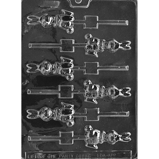 Clear plastic chocolate lollipop mold with multiple seated bunny cavities, each showing a smiling rabbit with upright ears and built-in stick slots on a dark background.