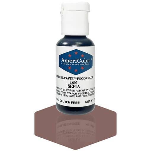 A bottle of AmeriColor Sepia soft gel paste food coloring with a white cap, blue label, and red stars, positioned on a sepia-brown reflective surface with the bottle’s reflection clearly visible.