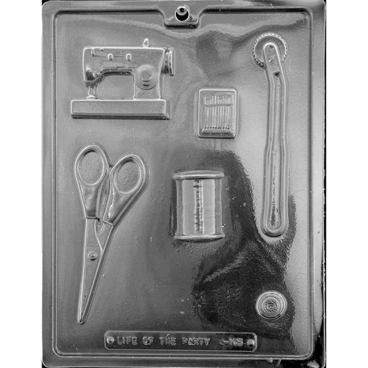 Clear six-cavity sewing kit assortment chocolate mold with a sewing machine, scissors, thread spool, needle packet, tracing wheel, and button.
