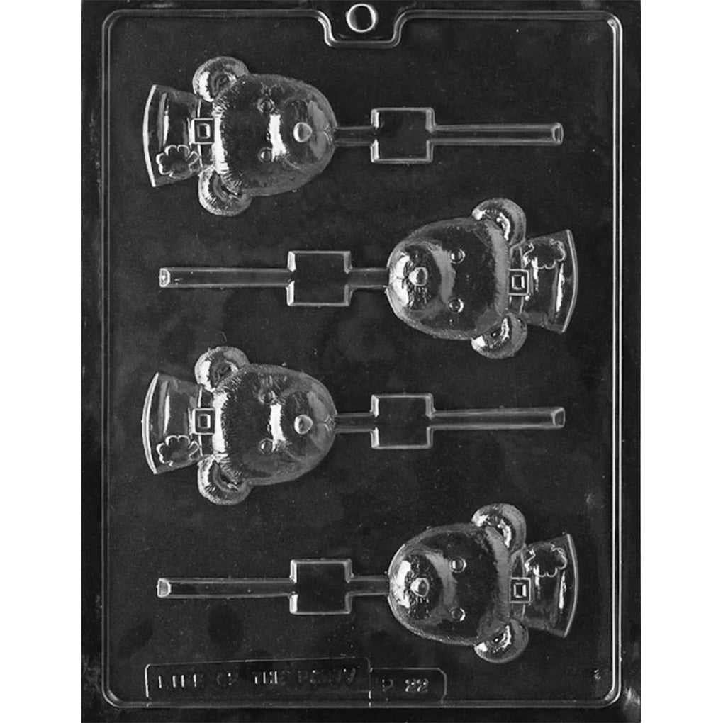 Shamrock bear chocolate lollipop mold with four teddy bear head cavities, each bear wearing a small cap with a shamrock detail and a built-in lollipop stick channel, shown in clear plastic.