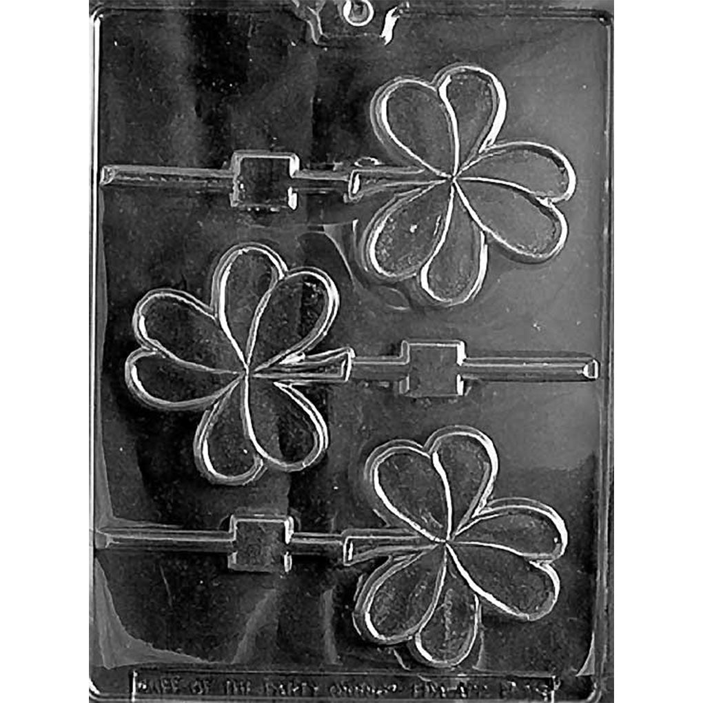 Clear plastic chocolate mold featuring three large shamrock-shaped lollipop cavities, each with three heart-shaped leaves and a slot for a lollipop stick.