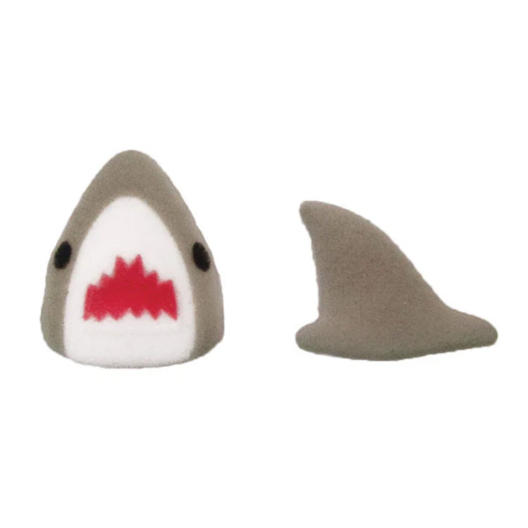 Pressed sugar shark cupcake toppers including a gray and white shark head with a red mouth and two black eyes, plus a separate gray shark fin.