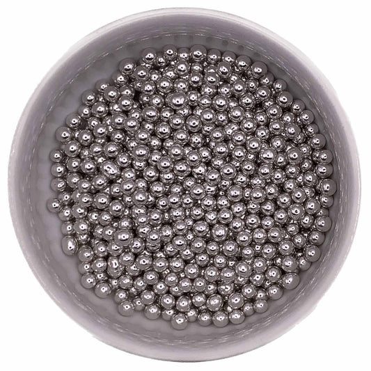 Silver 4mm dragees in a round container, showing small metallic decorative balls used for cake and cookie decoration.