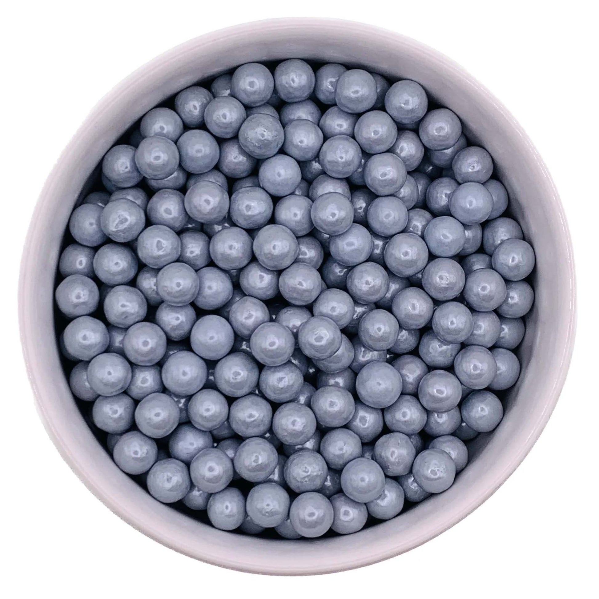 Close-up of 7mm silver sugar pearls in a bowl, with a metallic candy coating for decorating cakes, cupcakes, and cookies.