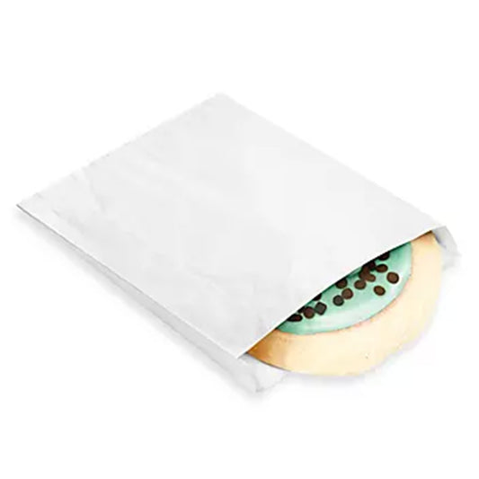 White paper single-serve cookie bag with a round iced cookie partially visible inside, shown on a white background.