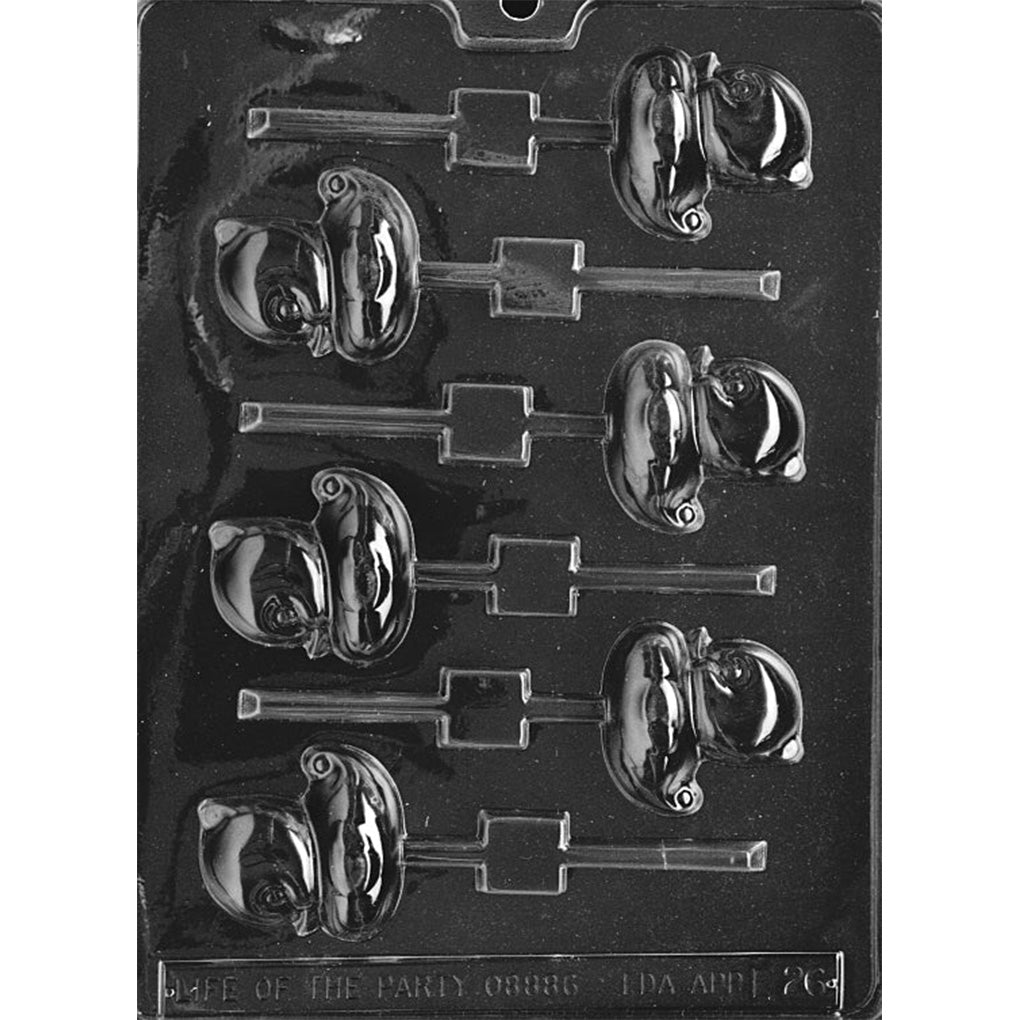 Clear plastic chocolate lollipop mold with multiple small duck-shaped cavities, showing raised duckling details and built-in stick slots on a dark background.