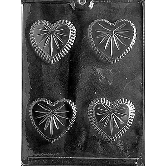 Clear Small Heart Candy Dish Chocolate Mold photographed against a black background with four cut-glass-style heart cavities for two assembled dishes