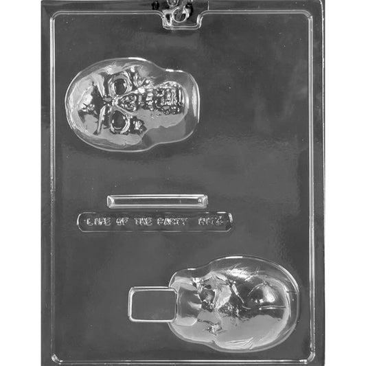 Clear plastic 3D skull chocolate mold photographed on a dark background, showing two skull half cavities (face side and back side) plus a small rectangular bar cavity on the tray.