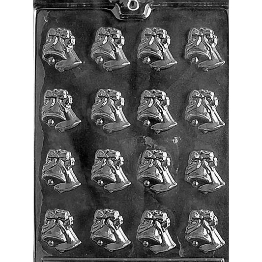 Clear plastic chocolate mold photographed on a dark background with multiple small bow-topped wedding bell cavities arranged in rows.
