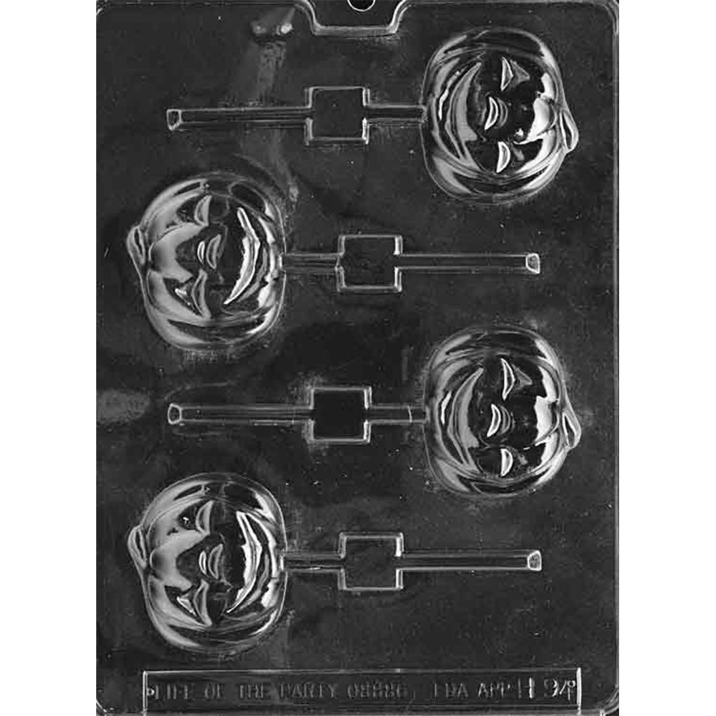 Clear Smiling Pumpkin Chocolate Lollipop Mold photographed against a black background with four jack-o’-lantern cavities featuring grinning faces and pumpkin ridges.