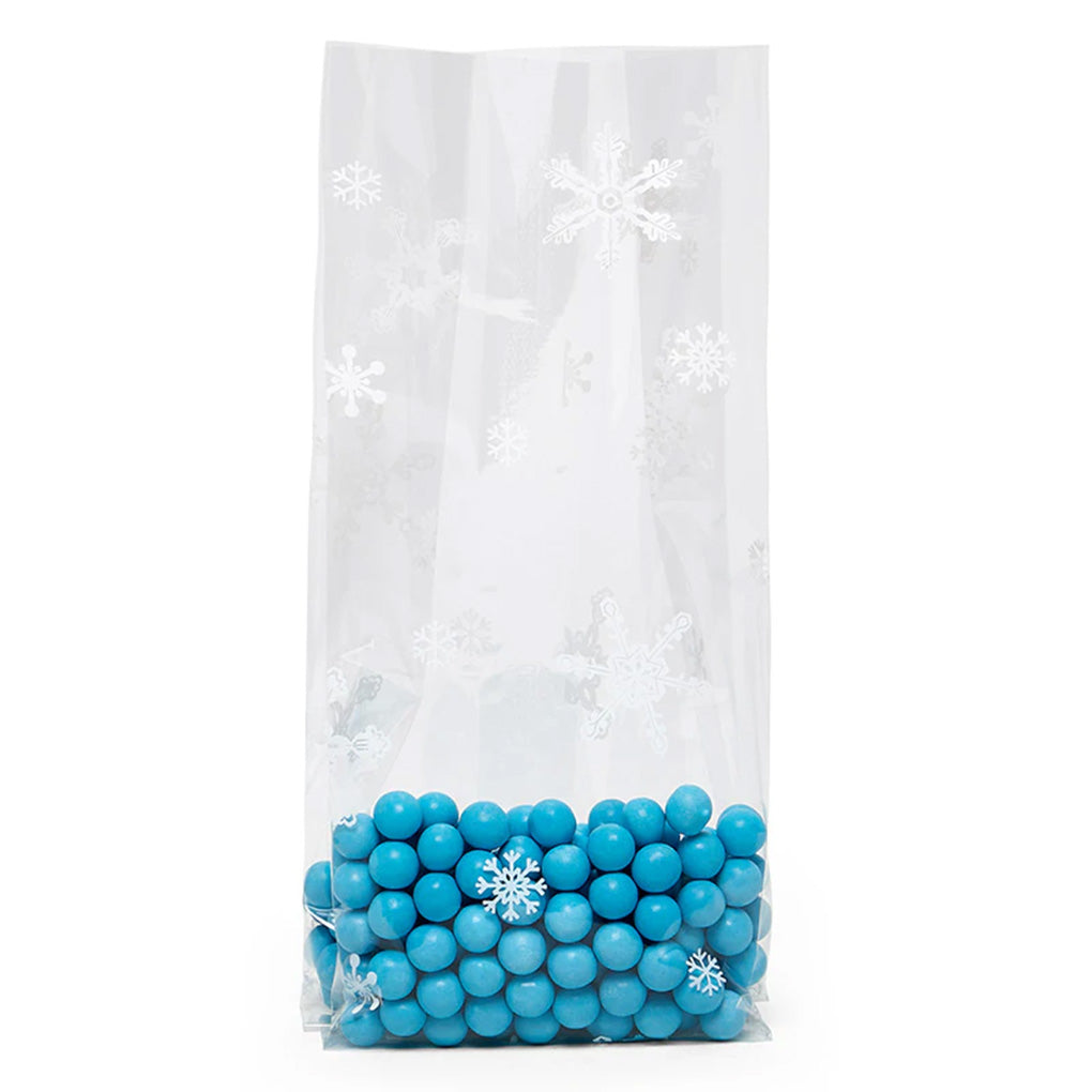 Clear large cello treat bag with white snowflake print, shown holding bright blue candy balls at the bottom.
