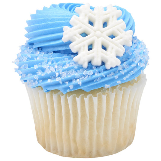 Vanilla cupcake topped with blue frosting, white sugar crystals, and a white pressed sugar snowflake.